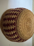 Vintage Hand-Woven Round Basket with Brownish Red Design